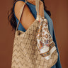 Chic Cityscape Faux Leather Woven Tote in Warm Taupe Image - 1