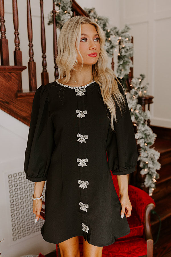 Elegant little black dress with rhinestone embellishments, perfect for a classy holiday look.