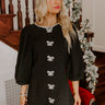 Elegant little black dress with rhinestone embellishments, perfect for a classy holiday look.