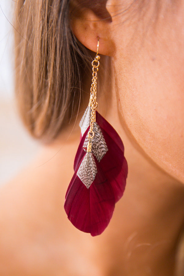 The Jet Setter Feather Earrings In Wine